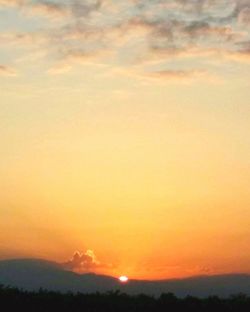 Scenic view of landscape against sky at sunset