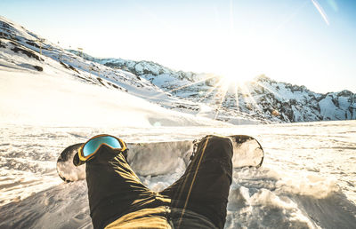 Low section of person on snowcapped mountain