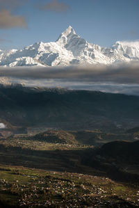 Scenic view of snowcapped mountains against sky