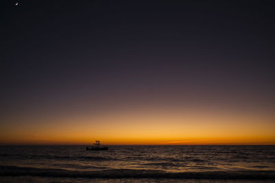 Scenic view of sea against orange sky