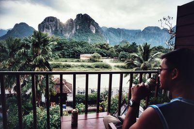 Woman looking at view from balcony