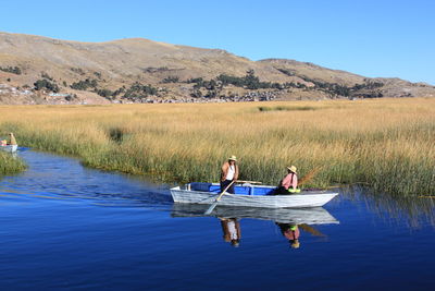 Scenic view of calm lake against mountain range