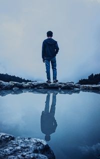 Rear view of man standing in water