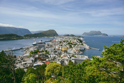 Scenic view of sea by city against sky