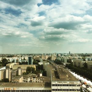 Cityscape against cloudy sky