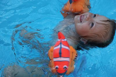 High angle view of boy swimming in pool