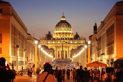 Crowd visiting st peter basilica at night