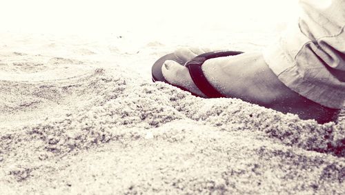 Low section of man on sand