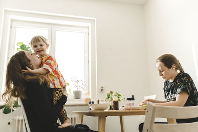 Family with daughter sitting at table