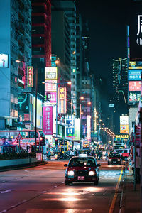 Cars on city street at night