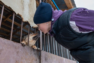 Girl volunteer in the nursery for dogs. shelter for stray dogs.