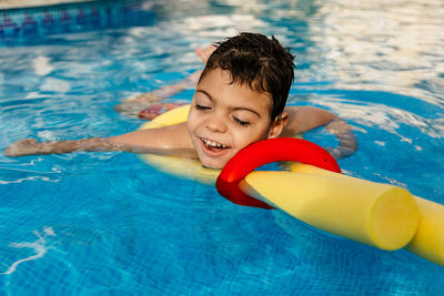 Smiling boy swimming in pool