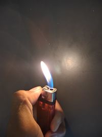 Person holding burning candle