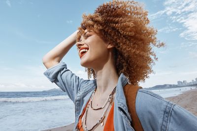 Portrait of young woman looking at beach