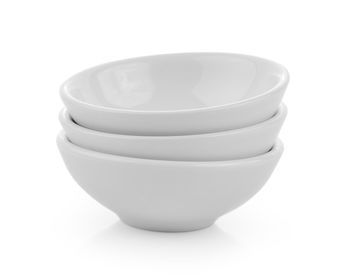 Close-up of bowls against white background