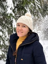 Portrait of young woman in warm clothes during winter