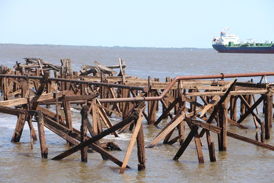 Pier on sea against clear sky