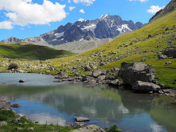 Scenic view of lake and mountains against sky