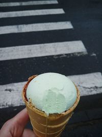 Close-up of hand holding ice cream cone