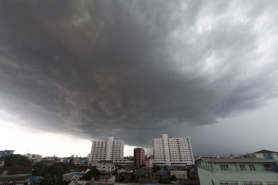 Buildings against cloudy sky