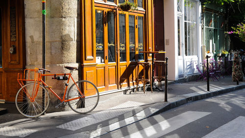 Bicycle parked on street by building