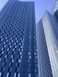 Low angle view of modern building against clear blue sky