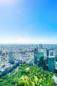 High angle view of buildings against blue sky