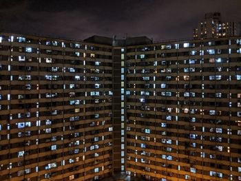 Low angle view of illuminated buildings against sky at night