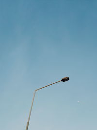 Low angle view of street light against clear blue sky