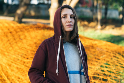 Portrait of young woman standing outdoors