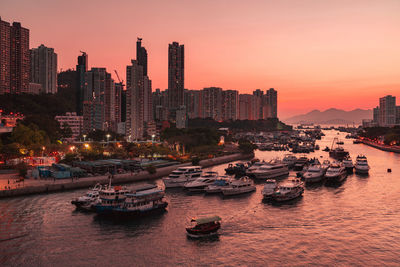 Panoramic view of sea and buildings against sky during sunset