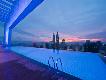 View of swimming pool at sunset