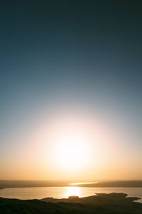 Scenic view of sea against clear sky during sunset