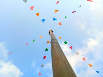 Low angle view of flags against sky