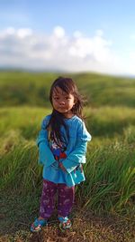 Portrait of girl standing on field