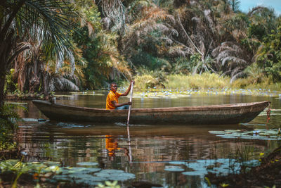 Scenic view of man in boat in lake