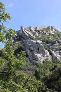 Low angle view of rocks against clear sky