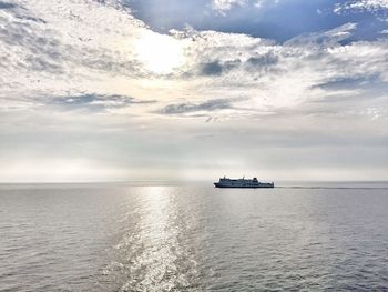 Ship sailing on sea against sky