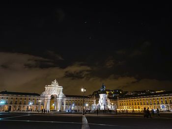 Illuminated city against sky at night