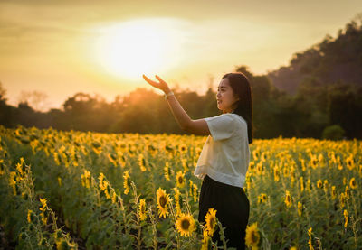 Side view of woman standing on field