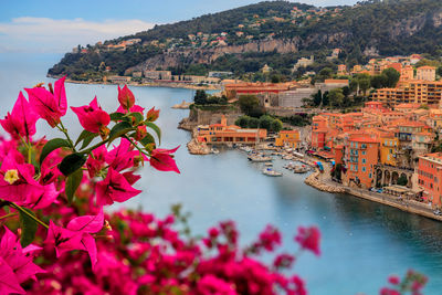 High angle view of townscape by sea against sky