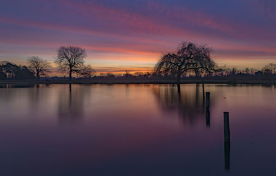 Scenic view of lake against sky during sunset