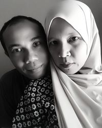 Close-up portrait of couple sitting at home