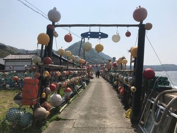 Lanterns hanging in row against sky