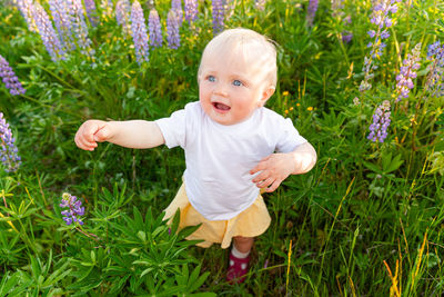 Portrait of boy standing amidst plants