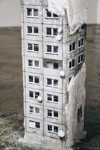 Close-up of building by sea against sky