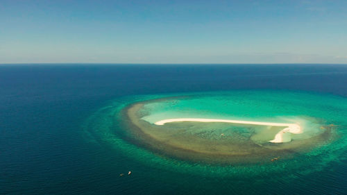 Aerial view of sea against blue sky