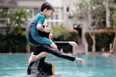 Sibling enjoying their time together in a swimming pool