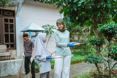 Portrait of woman standing against plants