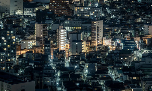 Aerial view of illuminated buildings in city at night